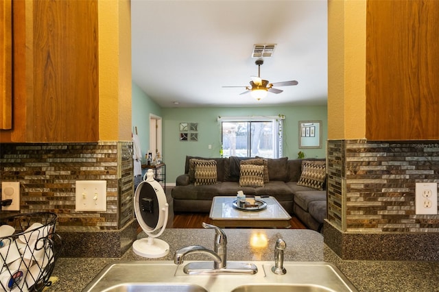 living room with ceiling fan, sink, and wood-type flooring