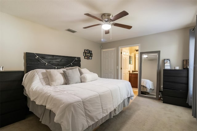 bedroom featuring ceiling fan, light colored carpet, and ensuite bathroom