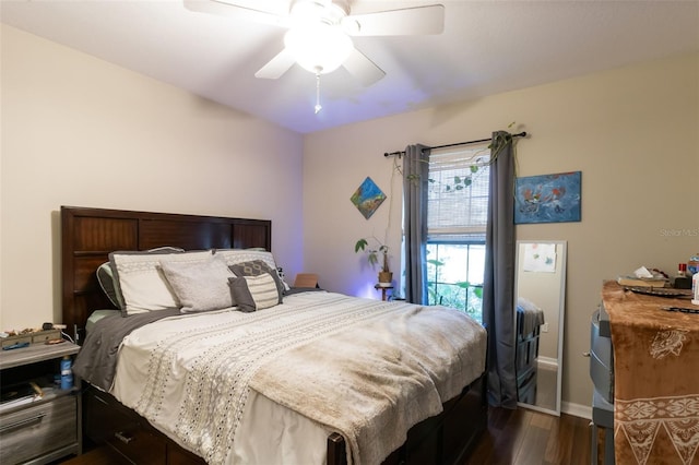 bedroom featuring ceiling fan and dark wood-type flooring