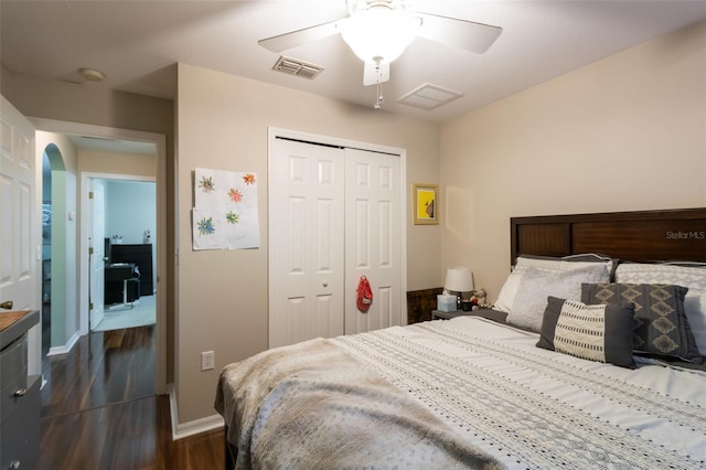 bedroom featuring a closet, ceiling fan, and dark hardwood / wood-style floors