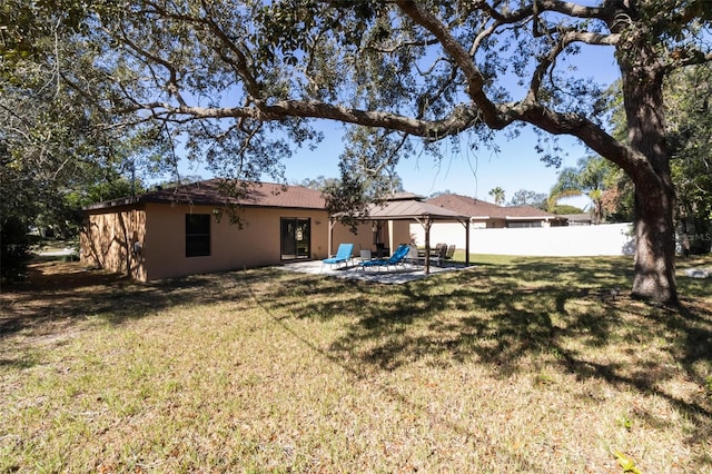 rear view of property with a patio area and a yard