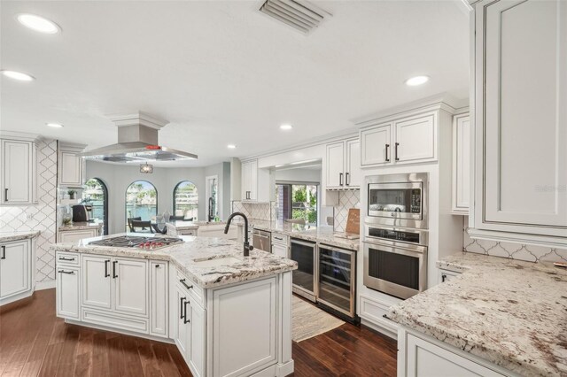 kitchen featuring wine cooler, dark wood-style flooring, visible vents, appliances with stainless steel finishes, and ventilation hood