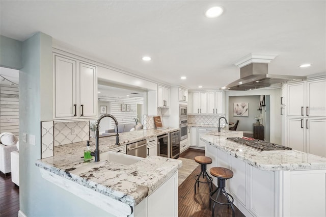 kitchen featuring range hood, a center island with sink, stainless steel appliances, dark wood-type flooring, and a sink