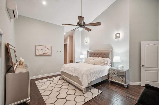 bedroom with wood finished floors, ceiling fan, baseboards, and a wall mounted AC