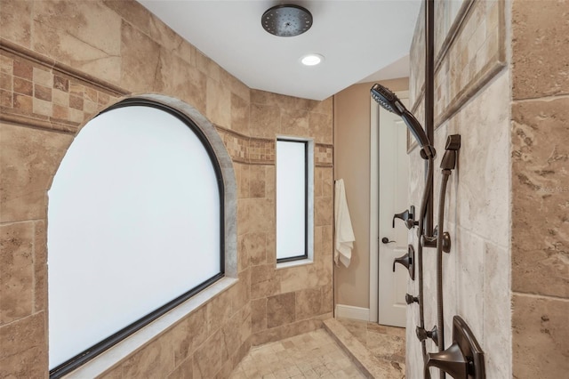 full bathroom featuring recessed lighting and tiled shower