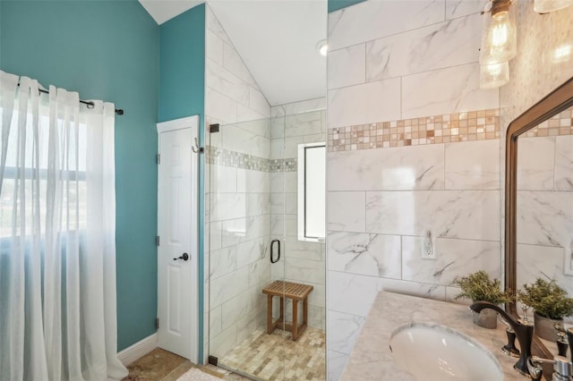 full bathroom with lofted ceiling, a stall shower, and vanity