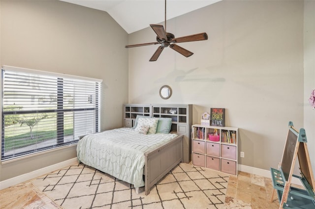 bedroom with stone finish floor, vaulted ceiling, and baseboards