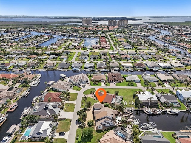 drone / aerial view with a water view and a residential view