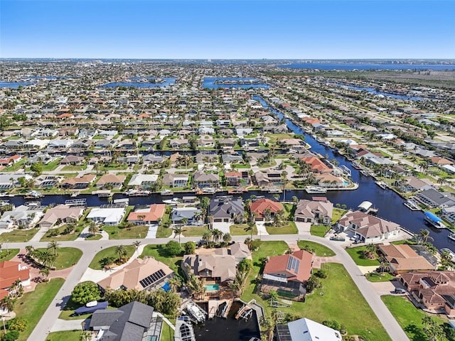 drone / aerial view with a residential view and a water view