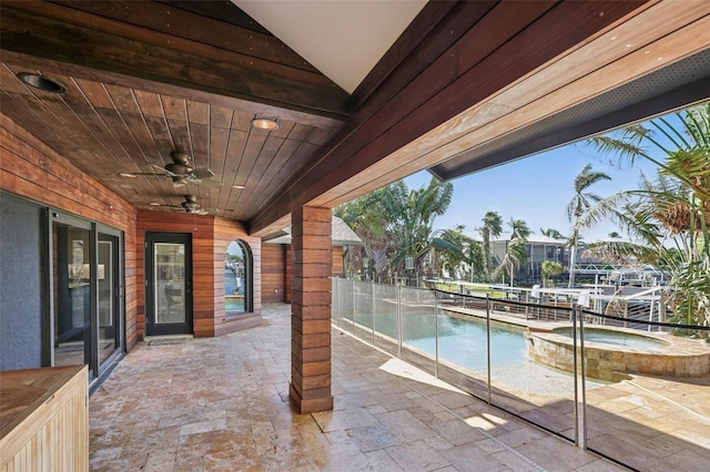 view of patio / terrace with a pool with connected hot tub and ceiling fan