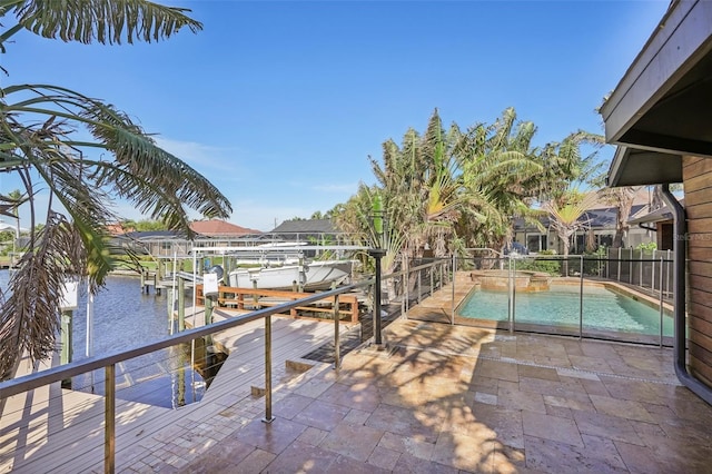 view of swimming pool with a dock, boat lift, and a pool with connected hot tub