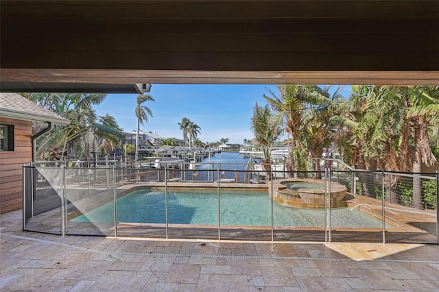 view of pool featuring a pool with connected hot tub and a water view