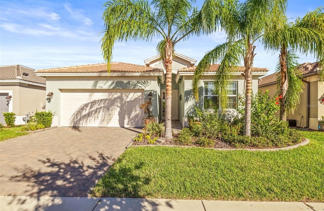 mediterranean / spanish home featuring a garage and a front yard