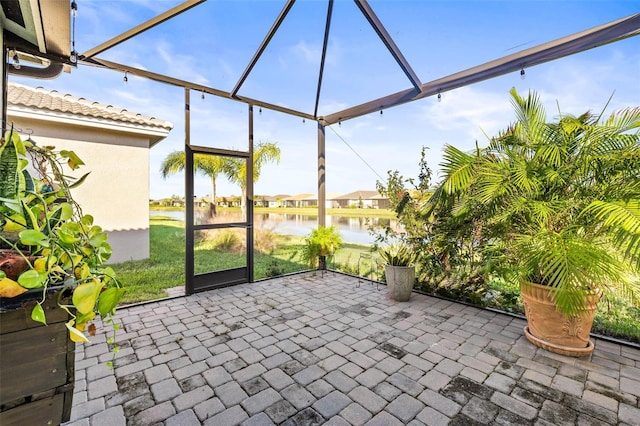 unfurnished sunroom featuring a water view