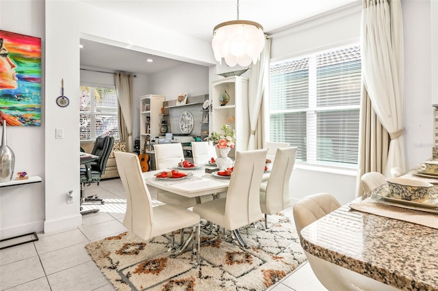 dining area with a notable chandelier and light tile patterned floors