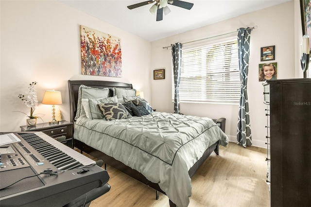 bedroom with ceiling fan and light hardwood / wood-style flooring