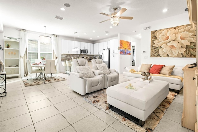 living room featuring light tile patterned floors and ceiling fan