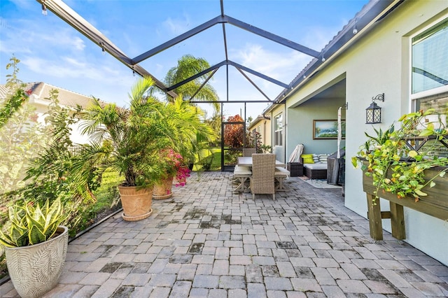 view of patio featuring glass enclosure and an outdoor living space