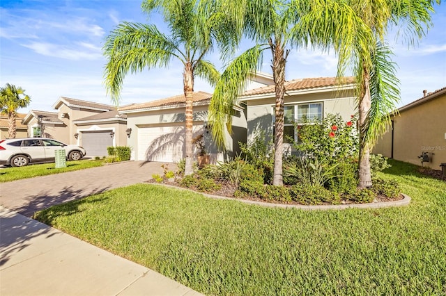 view of front of property with a garage and a front lawn