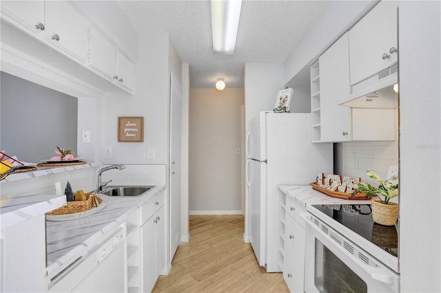 kitchen with sink, a textured ceiling, range hood, light hardwood / wood-style floors, and white cabinetry