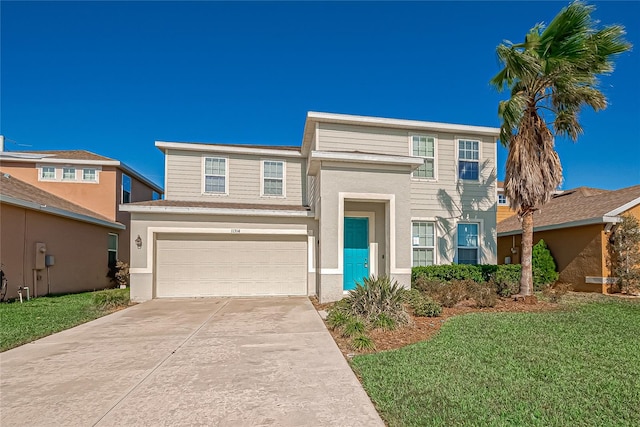 view of front of home with a front lawn and a garage