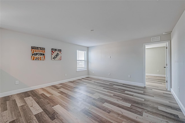 spare room featuring light hardwood / wood-style floors