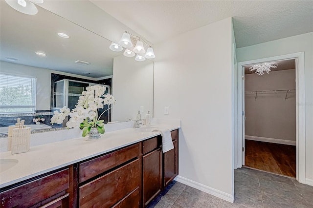 bathroom featuring tile patterned floors, vanity, and an enclosed shower