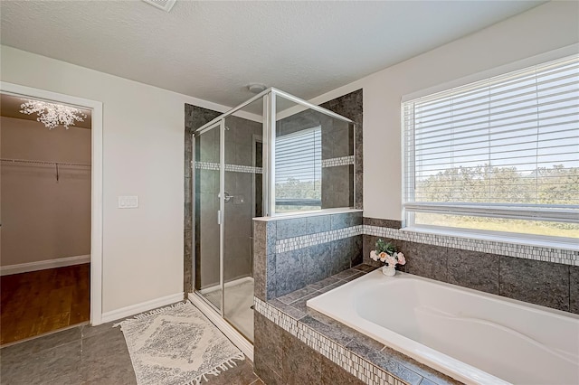 bathroom featuring tile patterned flooring, a textured ceiling, and independent shower and bath