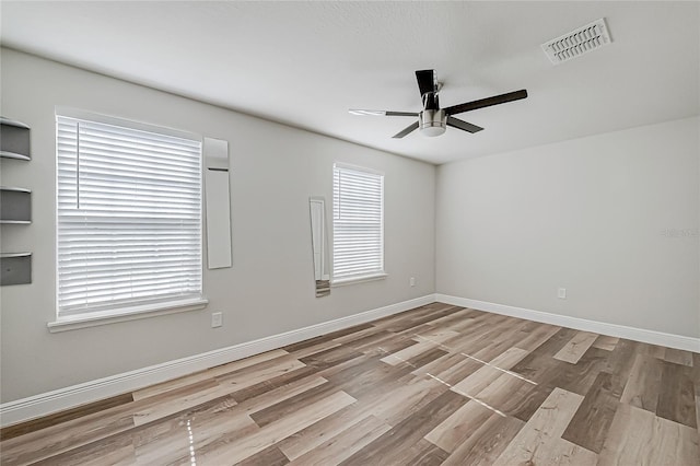 empty room with light hardwood / wood-style flooring and ceiling fan