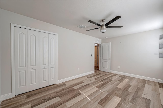 unfurnished bedroom featuring a closet, ceiling fan, and light hardwood / wood-style flooring