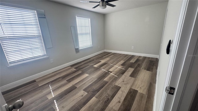 spare room featuring dark hardwood / wood-style floors and ceiling fan