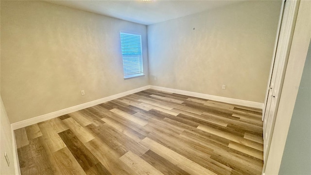 unfurnished room with hardwood / wood-style flooring