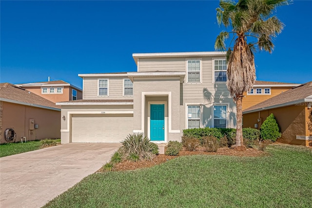 view of front of home with a front yard and a garage