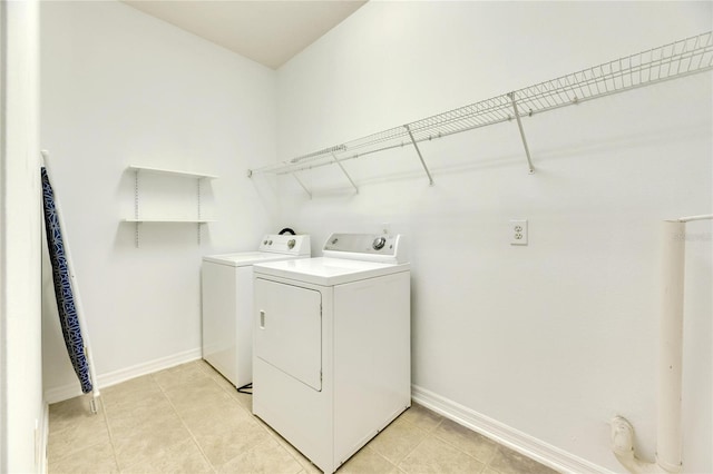 laundry area with light tile patterned flooring and washing machine and clothes dryer