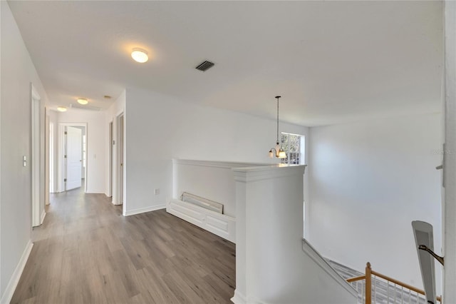 corridor with wood-type flooring