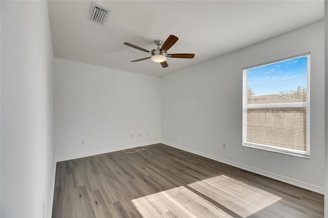 empty room with hardwood / wood-style floors and ceiling fan