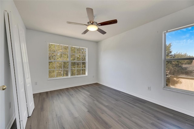 unfurnished bedroom with ceiling fan and dark wood-type flooring