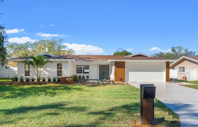 ranch-style home with a front yard and a garage