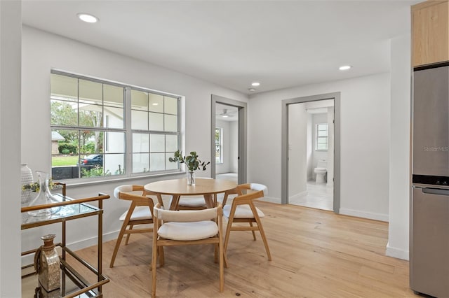 dining space featuring baseboards, recessed lighting, a wealth of natural light, and light wood-style floors