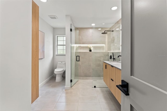 full bathroom with tile patterned flooring, toilet, vanity, baseboards, and a stall shower