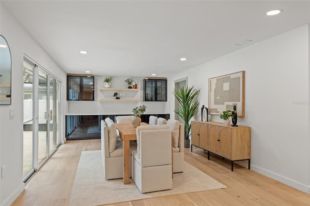 dining space featuring light wood-type flooring, baseboards, and recessed lighting