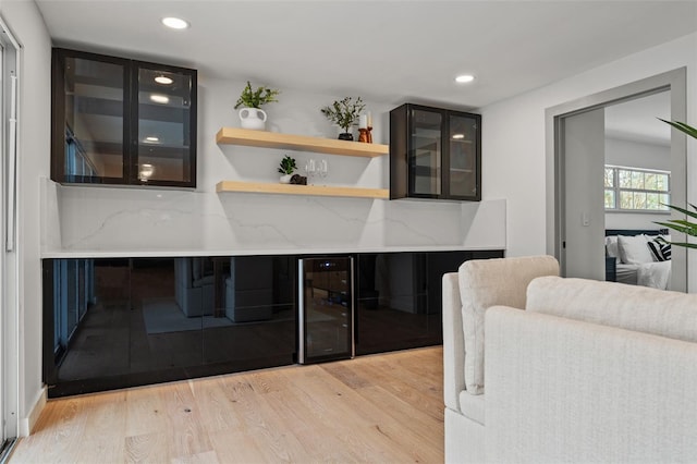 bar featuring a dry bar, light wood-style floors, wine cooler, and recessed lighting