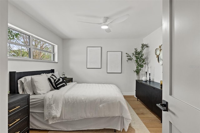 bedroom featuring light wood finished floors and a ceiling fan