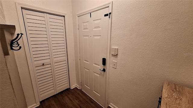 entryway with dark hardwood / wood-style flooring