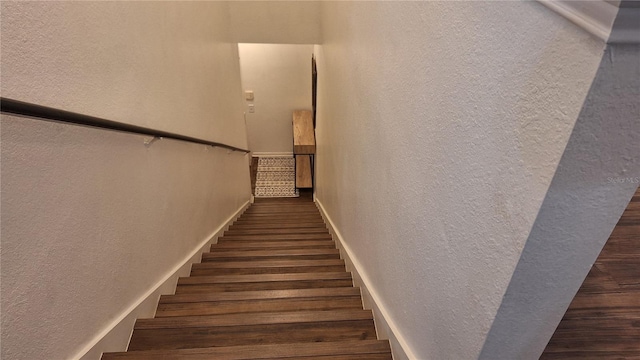 staircase featuring wood-type flooring