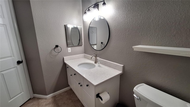 bathroom featuring tile patterned flooring, vanity, and toilet