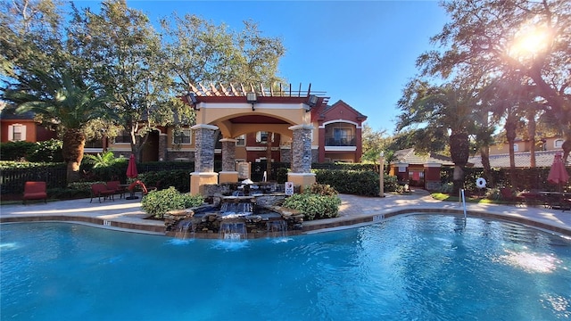 view of swimming pool featuring pool water feature and a patio area