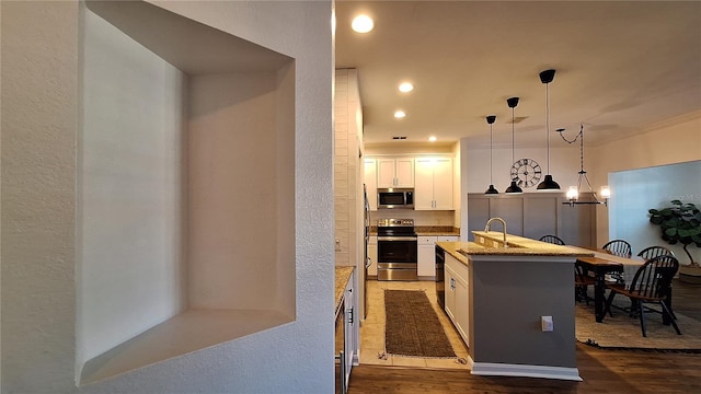 kitchen featuring a kitchen island, white cabinets, dark wood-type flooring, and appliances with stainless steel finishes