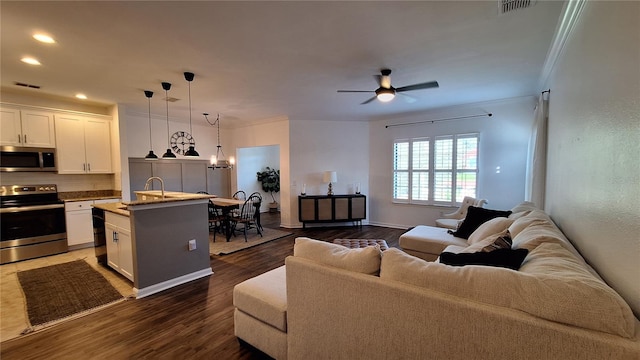 living room with crown molding, sink, ceiling fan with notable chandelier, and dark hardwood / wood-style floors