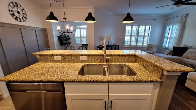 kitchen with white cabinets, light stone countertops, ornamental molding, and sink